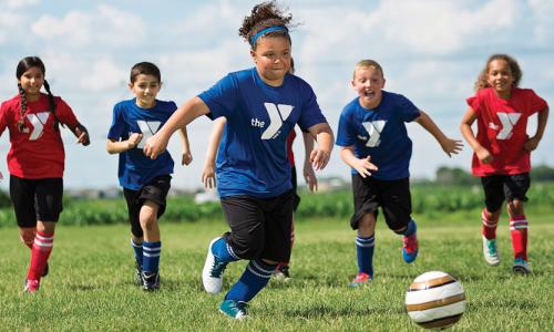 Kids running after ball