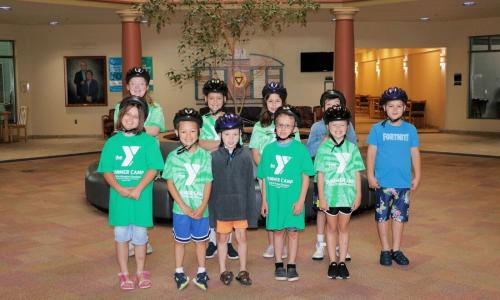 Group photo of campers wearing bike helmets