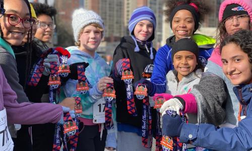 Group of girls with Cleveland Marathon medals.