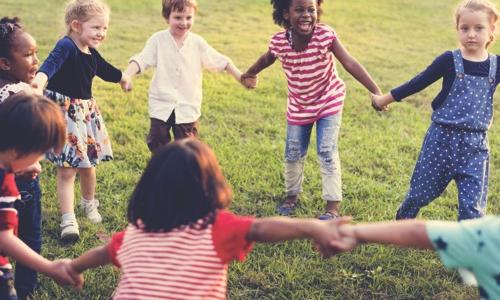 Group of children holding hands at day camp