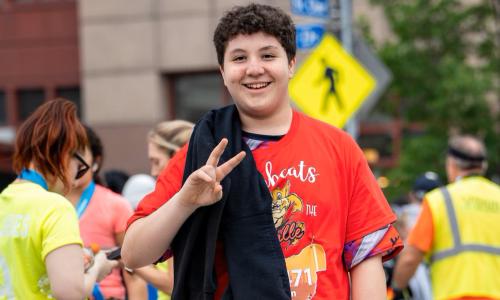We Run This City participant crosses the finish line