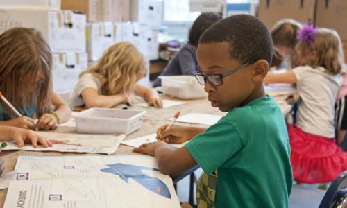Boy does drawing activity during summer camp