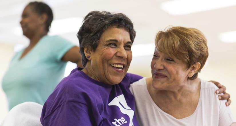 2 Women smiling, one in YMCA tshirt