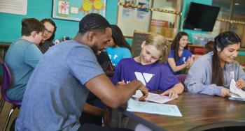 Y Staff member working with child during afterschool program