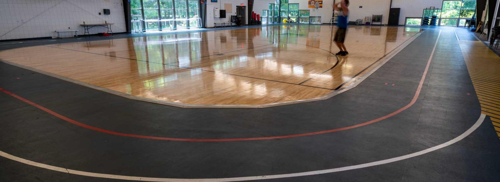 Indoor basketball court with walking track around it